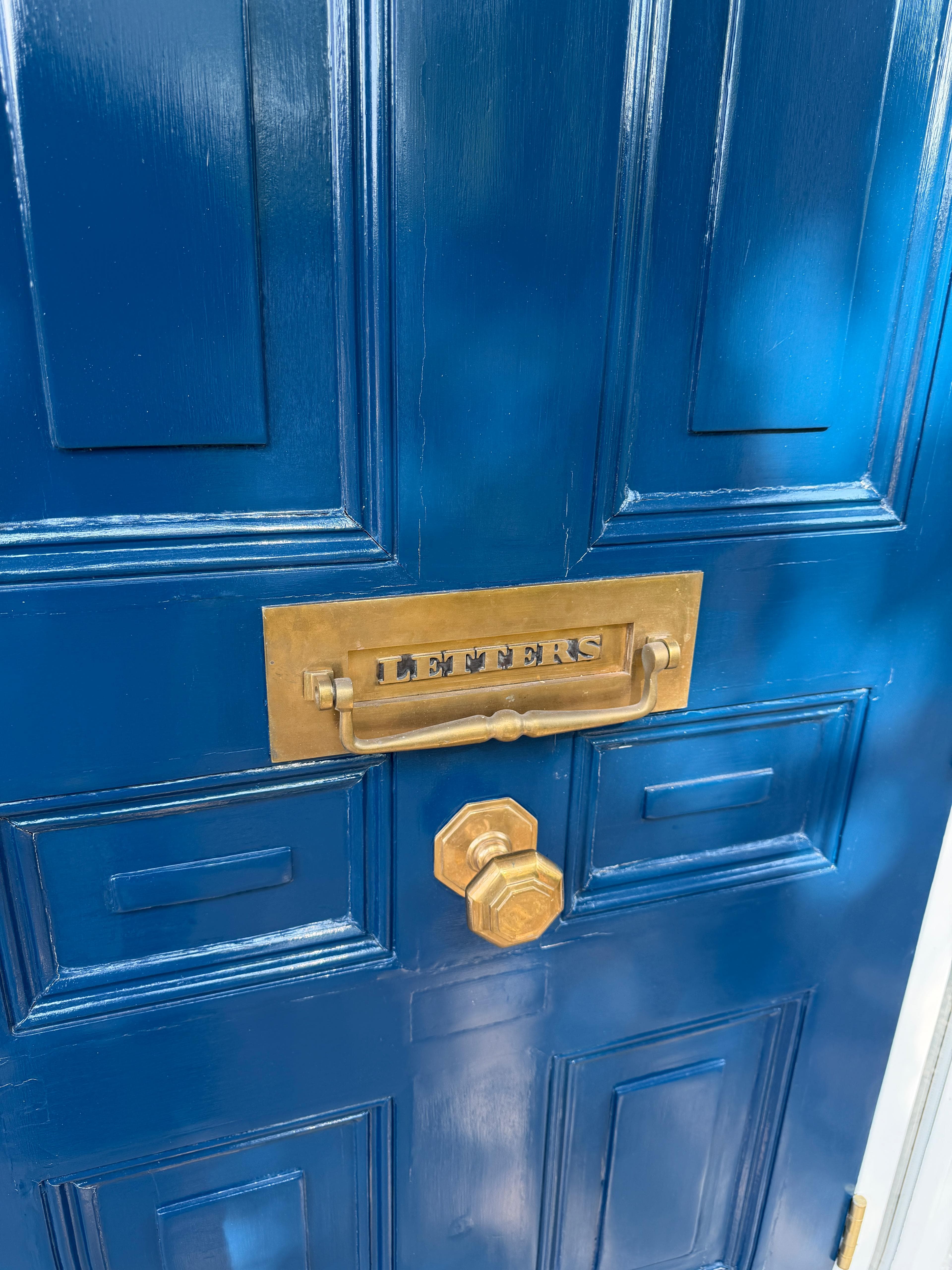 Blue front door with brass letterbox